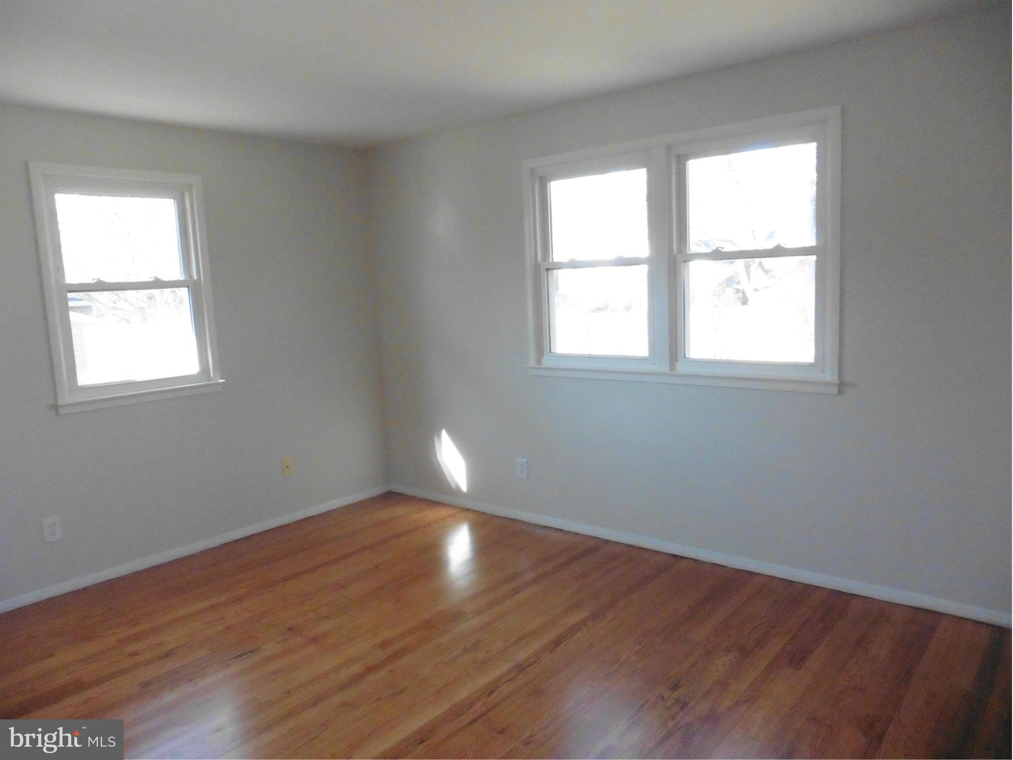 5227 Ravensworth Road Springfield, VA 22151 - Photo 10 of 27 an empty room with wooden floor and windows