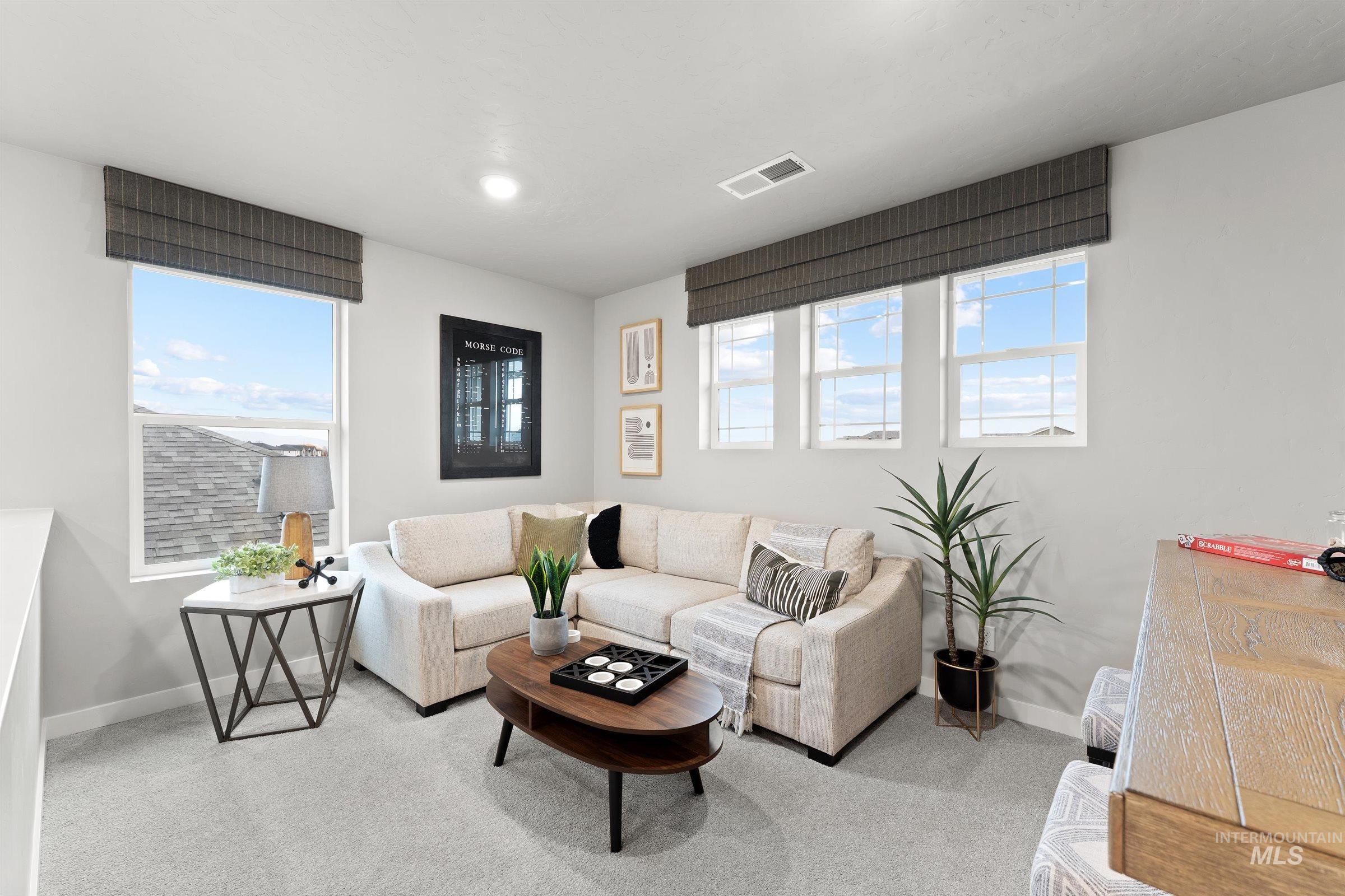 4141 South Colditz Way Meridian, ID 83642 - Photo 14 of 40 Carpeted living room with baseboards