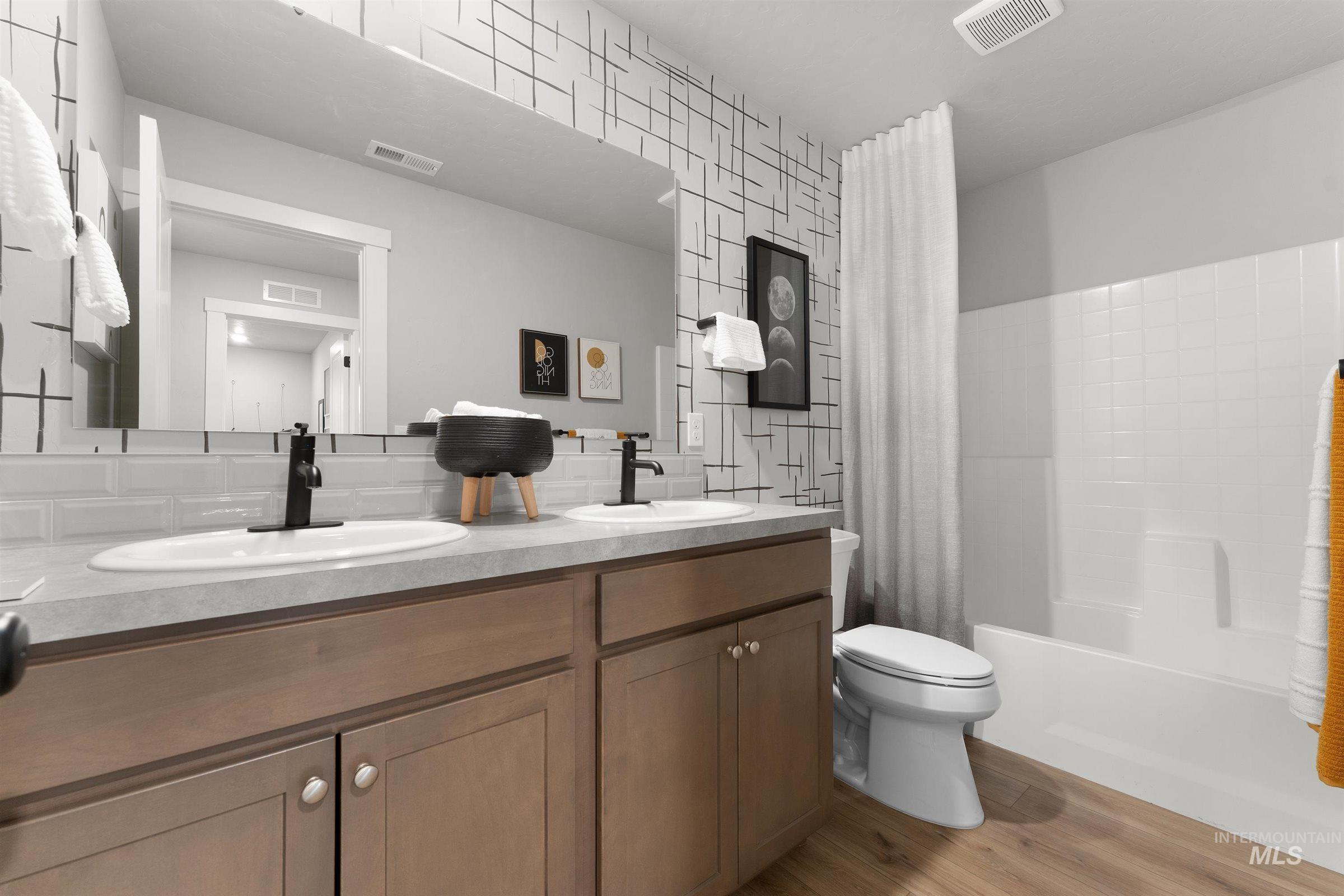 4141 South Colditz Way Meridian, ID 83642 - Photo 25 of 40 Bathroom with light wood-type flooring, double vanity, and shower / bath combination with curtain
