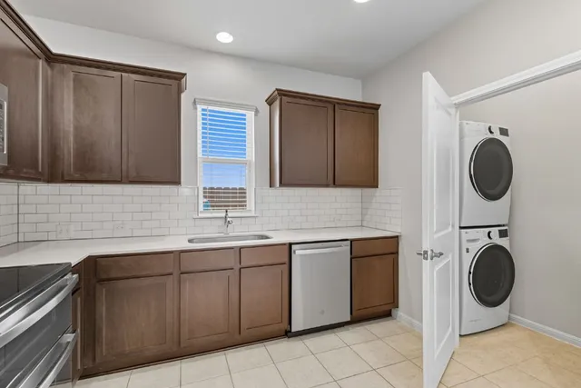 a kitchen that has a sink and a stove