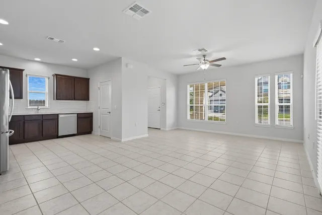 a view of an empty room with a kitchen
