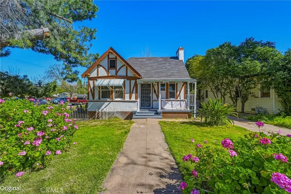 a front view of a house with a yard and fountain