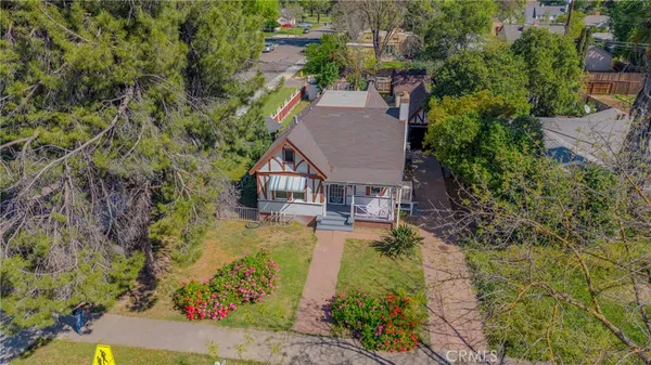 an aerial view of a house with swimming pool and garden