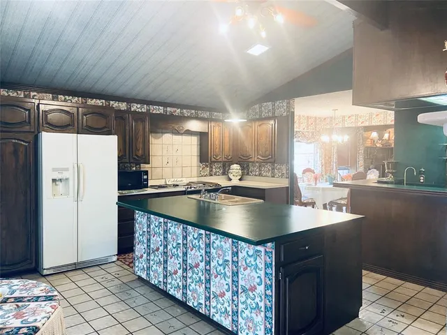 a kitchen with stainless steel appliances granite countertop a sink a counter top space and cabinets