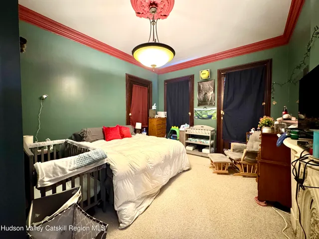 a view of a hallway with wooden floor and furniture