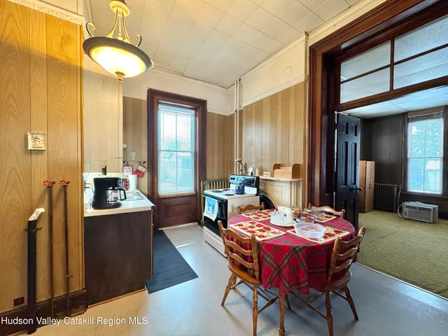 a bedroom with furniture and large window
