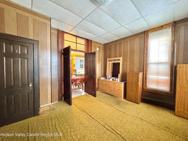 a bedroom with a bed dresser and a window