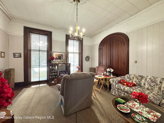 a living room with furniture and a chandelier