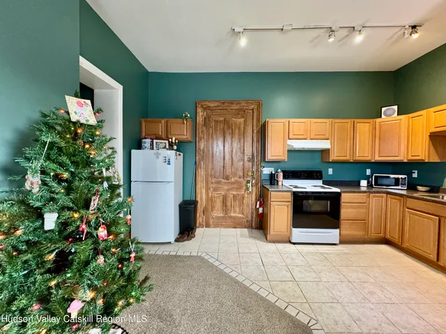 a bathroom with a granite countertop sink a toilet and mirror