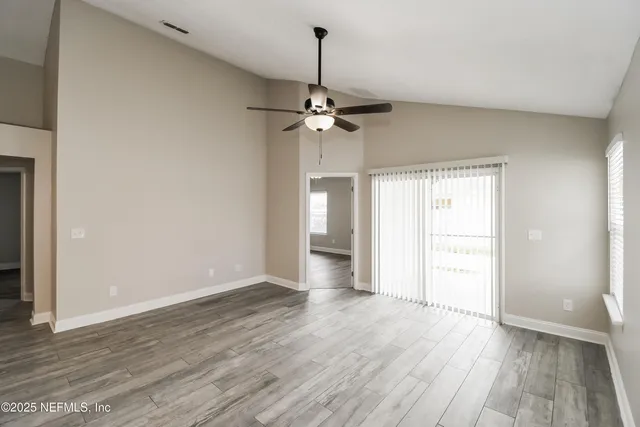 wooden floor in an empty room with a window