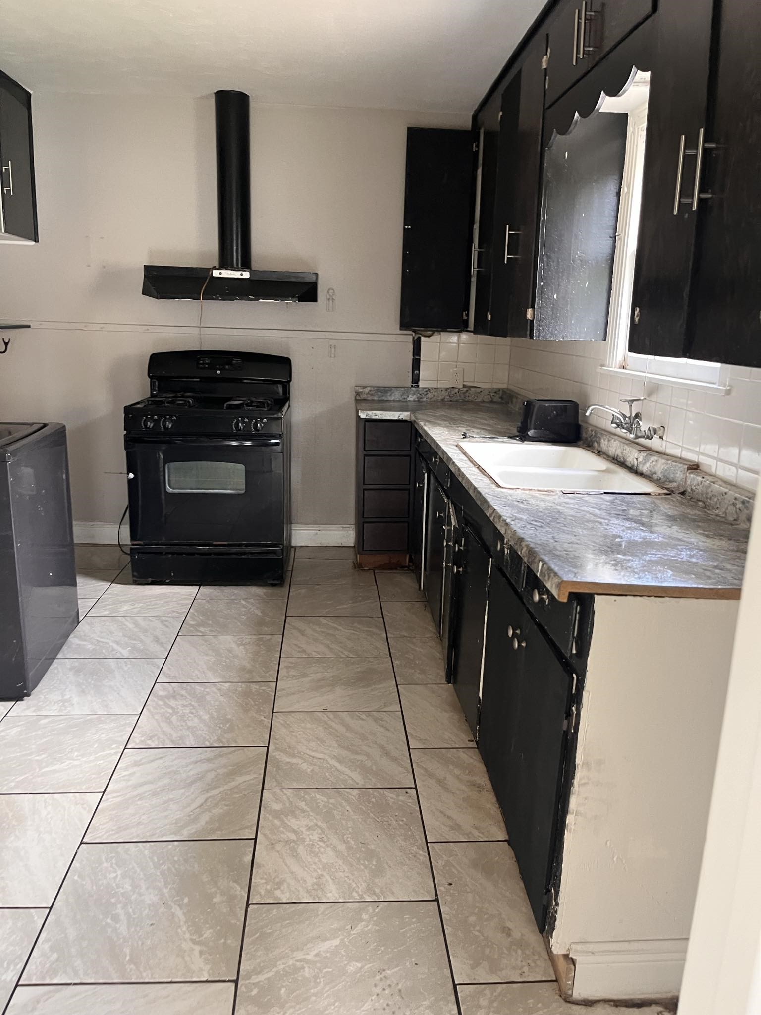 4980 Chambers Street Beaumont, TX 77705 - Photo 8 of 23 a kitchen with a sink and a stove