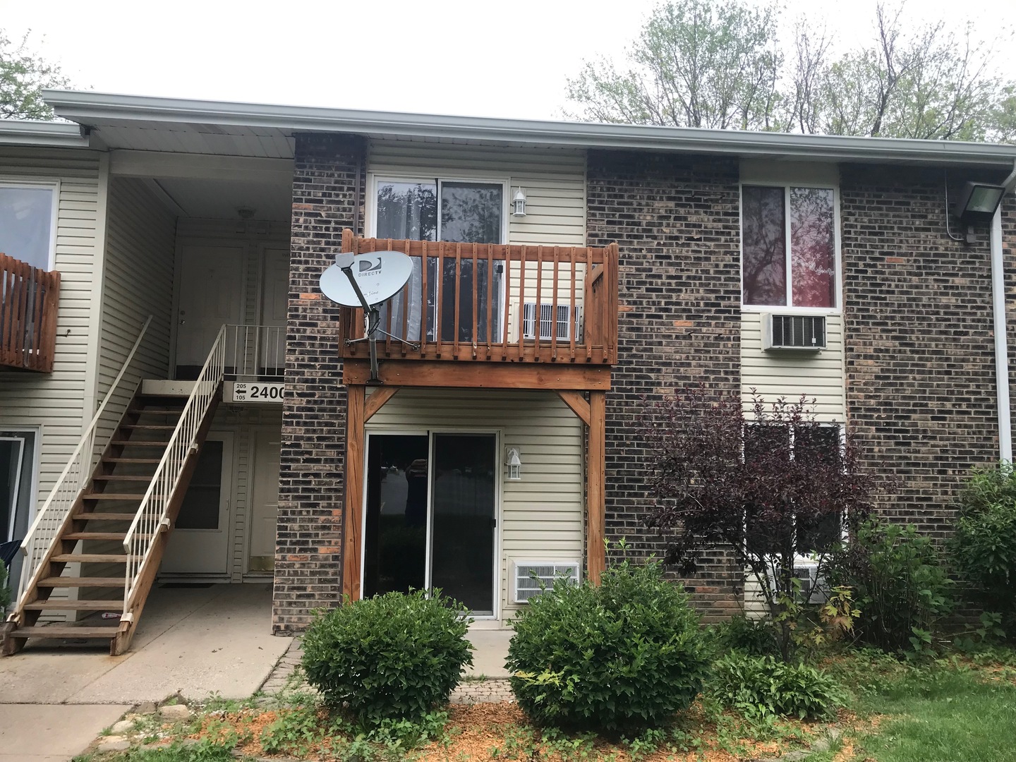 2400 Light Road, Unit 106 Oswego, IL 60543 - Photo 2 of 13 a front view of a house with garden