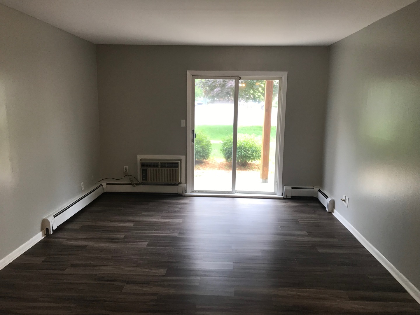2400 Light Road, Unit 106 Oswego, IL 60543 - Photo 3 of 13 a view of wooden floor and windows in a room