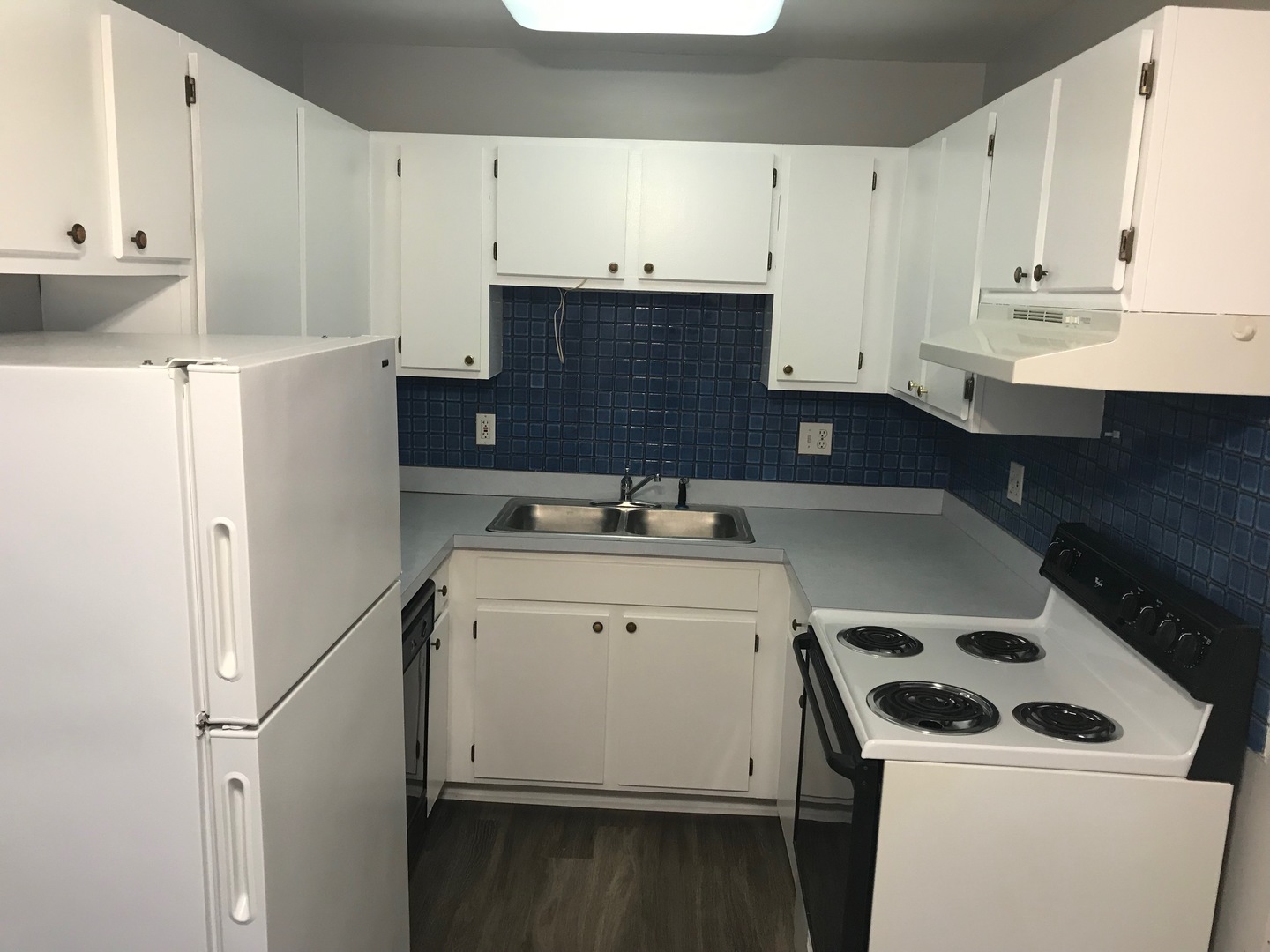 2400 Light Road, Unit 106 Oswego, IL 60543 - Photo 5 of 13 a kitchen with a sink a stove and white cabinets