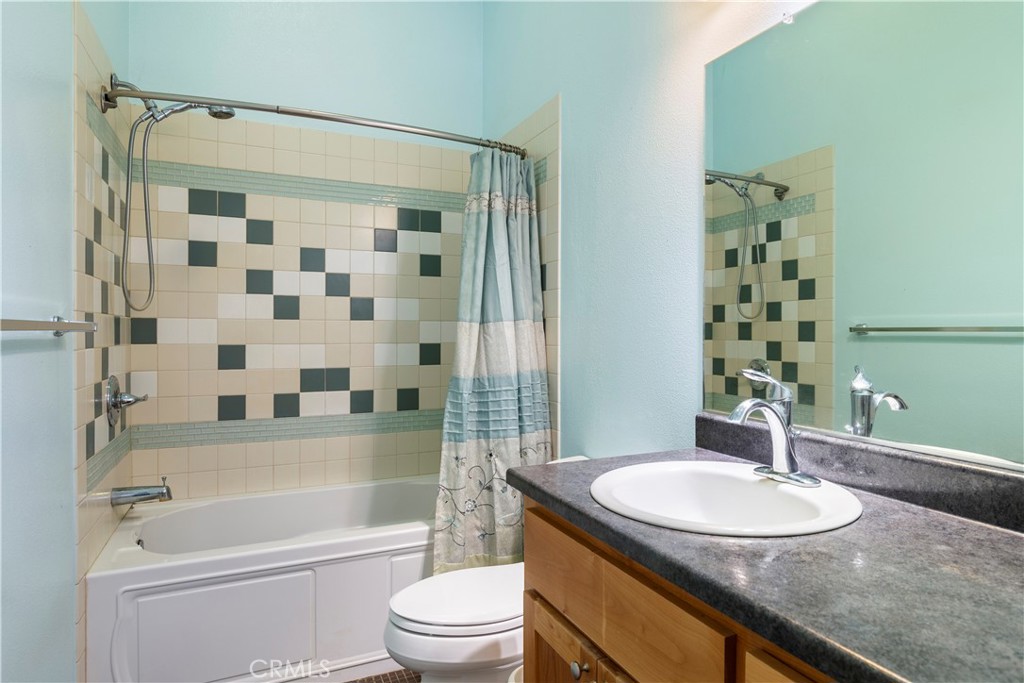 2145 Big Valley Road Lakeport, CA 95453 - Photo 11 of 45 a bathroom with a sink toilet a shower and a mirror