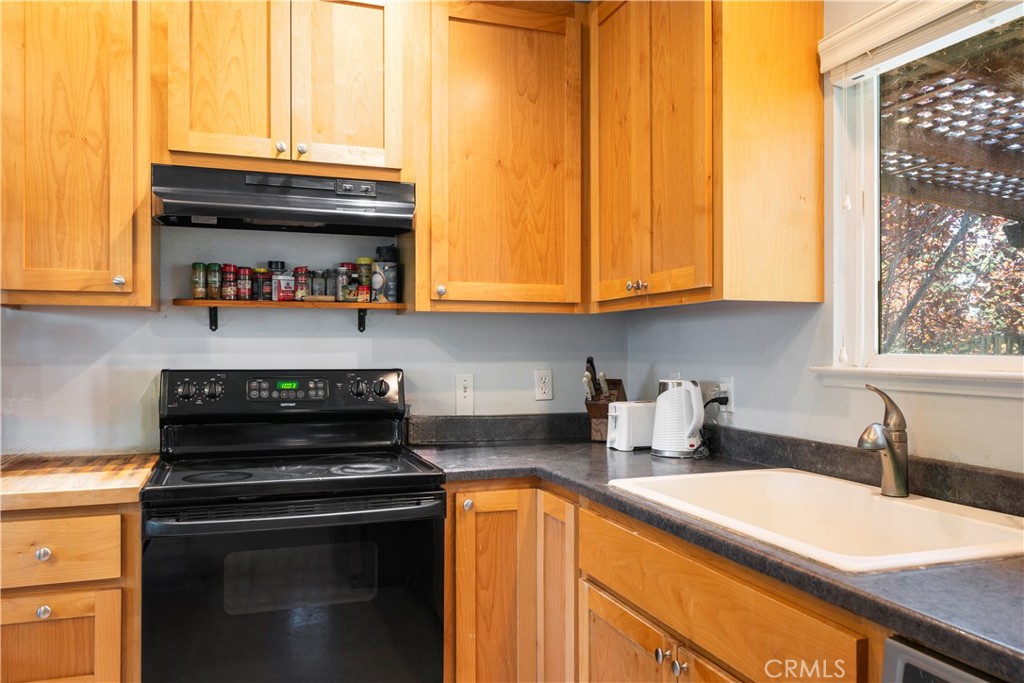 2145 Big Valley Road Lakeport, CA 95453 - Photo 12 of 45 a kitchen with stainless steel appliances granite countertop a sink and a white cabinets