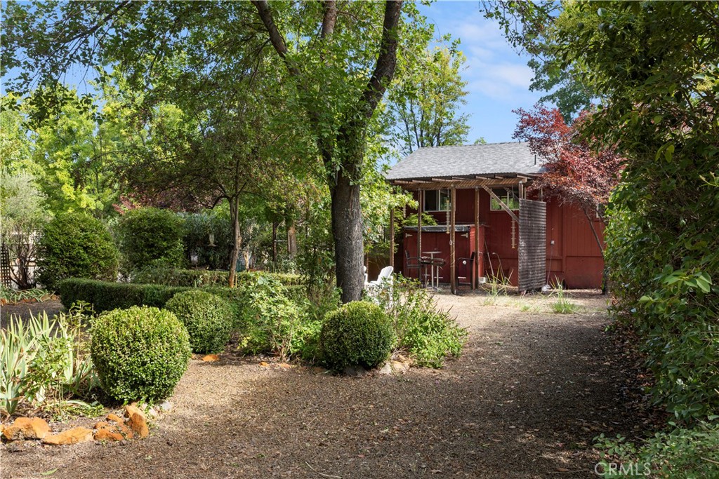 2145 Big Valley Road Lakeport, CA 95453 - Photo 26 of 45 a view of a patio with table and chairs potted plants and large tree