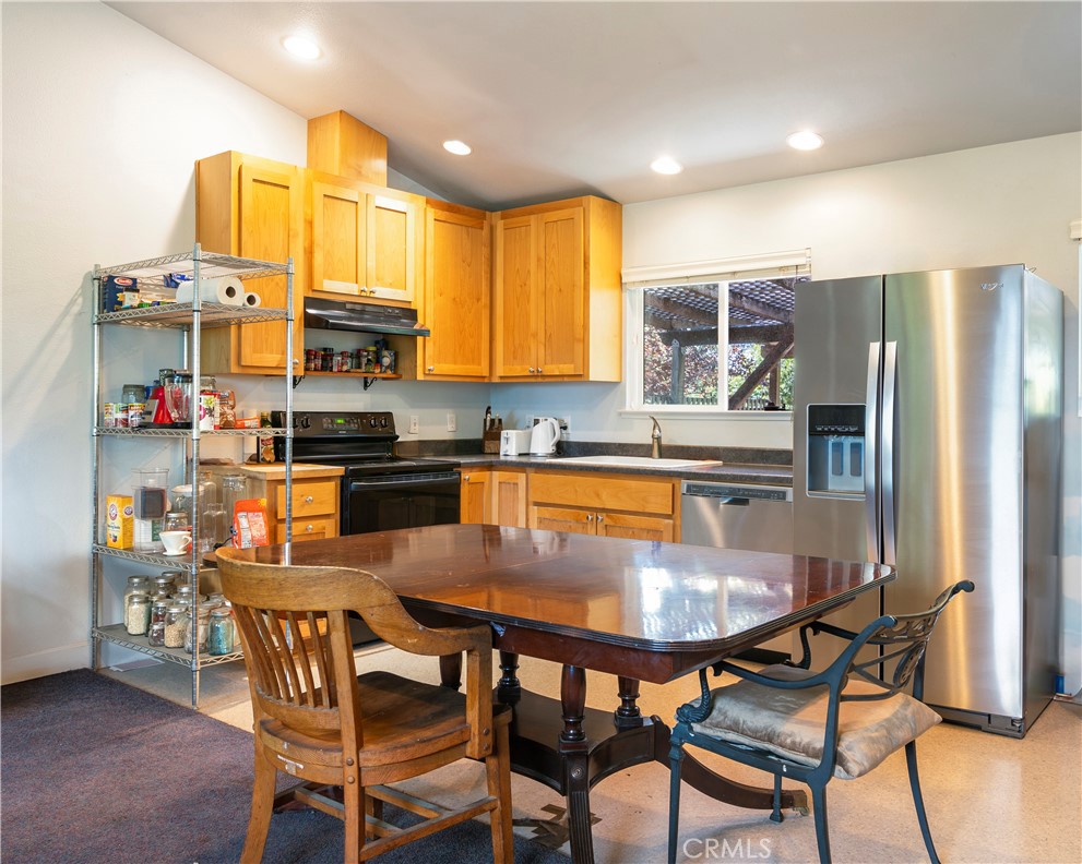 2145 Big Valley Road Lakeport, CA 95453 - Photo 4 of 45 a kitchen with stainless steel appliances a dining table chairs refrigerator and microwave