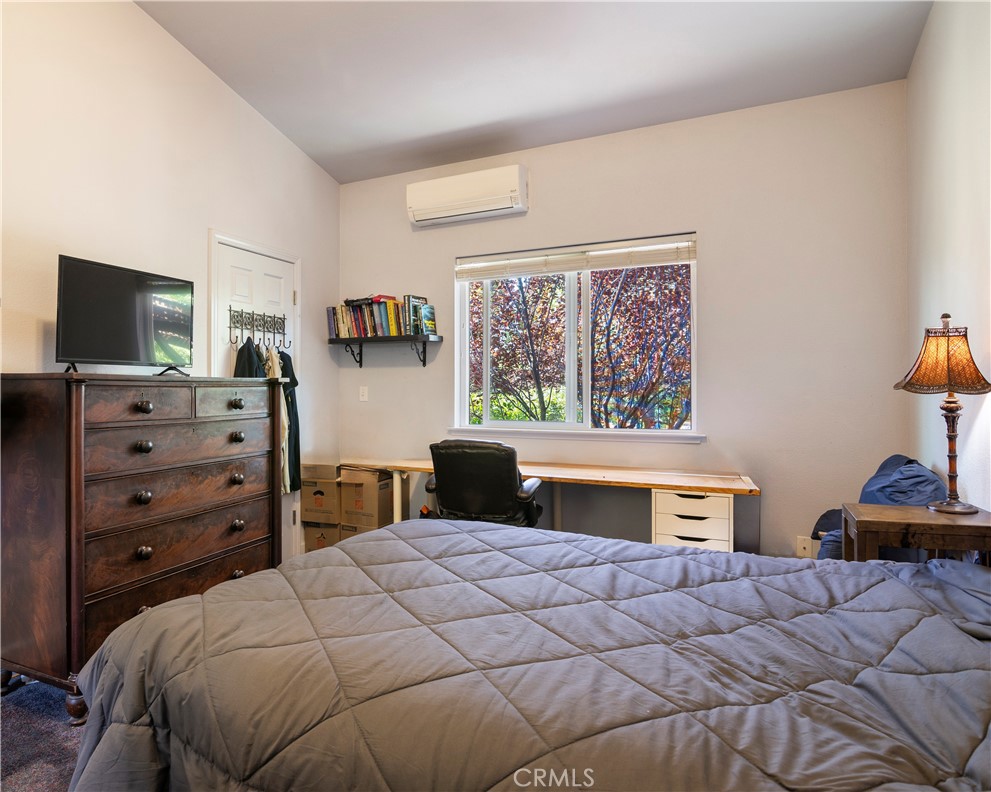2145 Big Valley Road Lakeport, CA 95453 - Photo 5 of 45 a bedroom with a bed and a flat tv screen on dresser