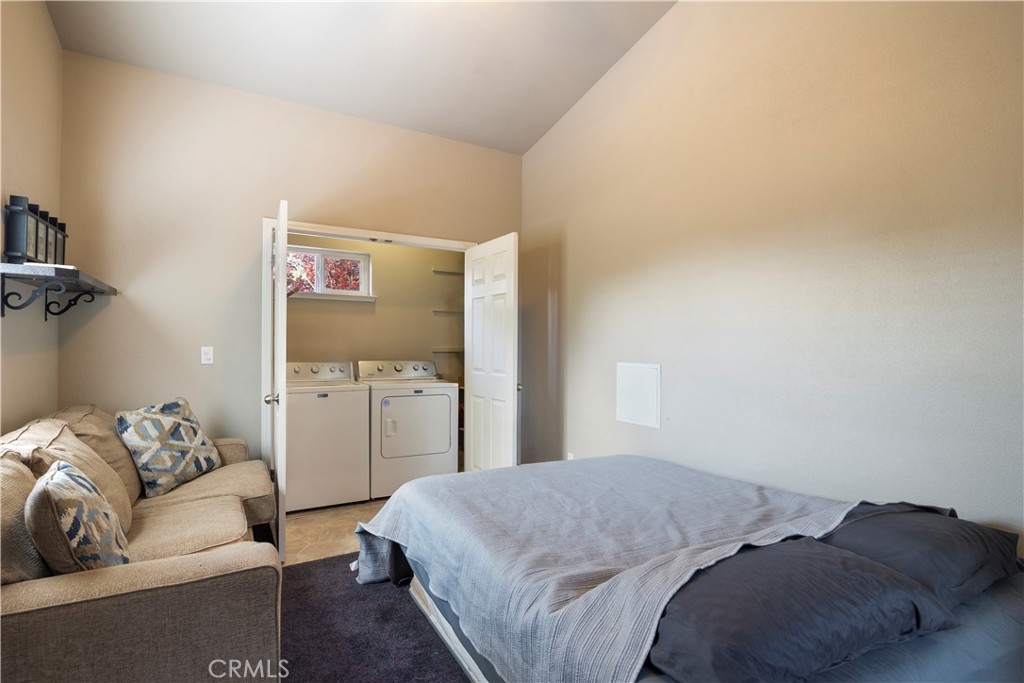 2145 Big Valley Road Lakeport, CA 95453 - Photo 9 of 45 a bed room with a bed and a couch