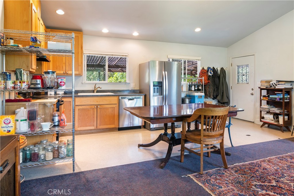 2145 Big Valley Road Lakeport, CA 95453 - Photo 10 of 45 a dining area with stainless steel appliances a dining table and chairs