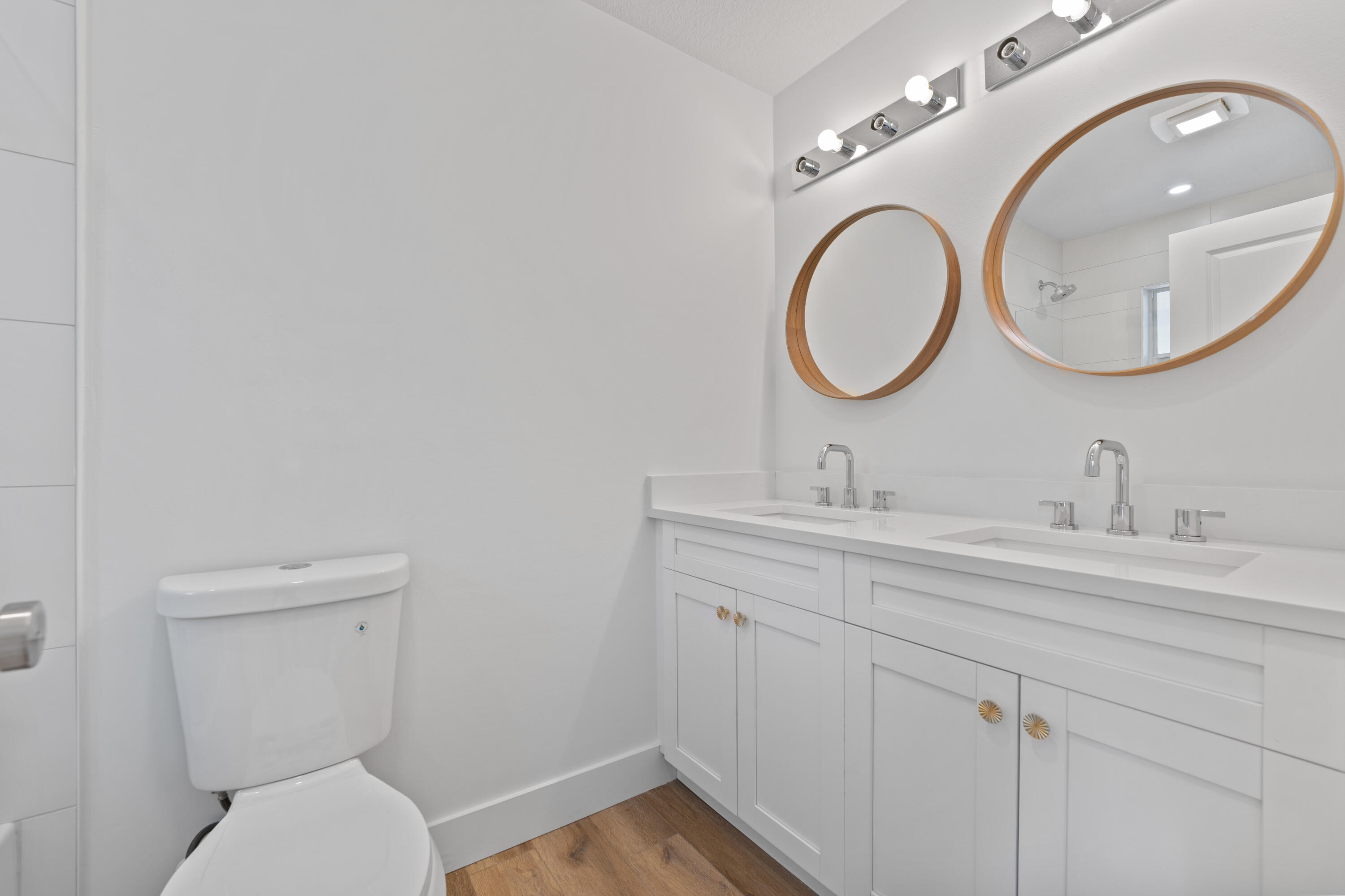 1279 Beach Road, Unit 2 Singer Island, FL 33404 - Photo 11 of 20 a bathroom with a toilet a sink and a mirror