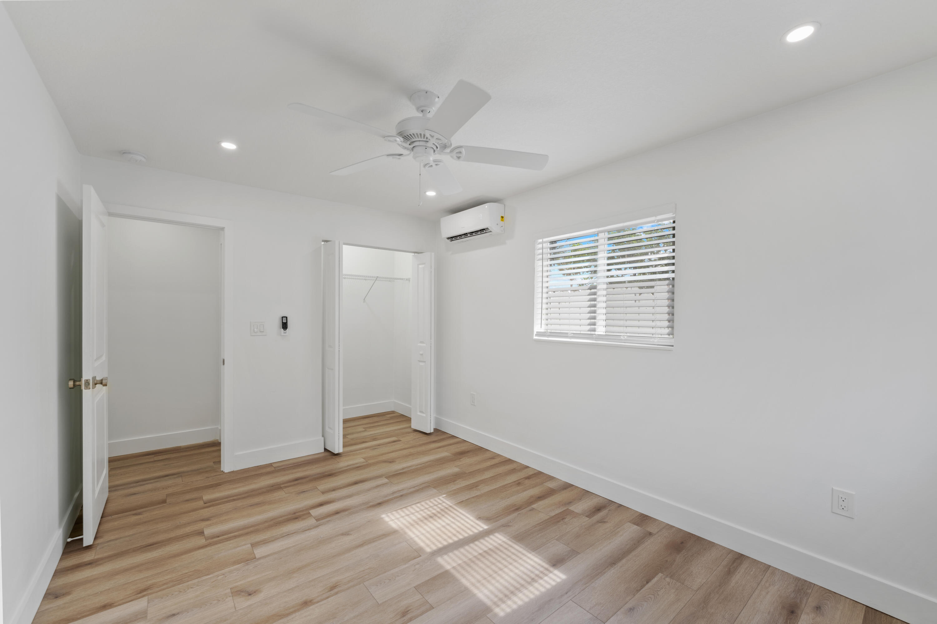 1279 Beach Road, Unit 2 Singer Island, FL 33404 - Photo 15 of 20 a view of a livingroom with wooden floor and a ceiling fan