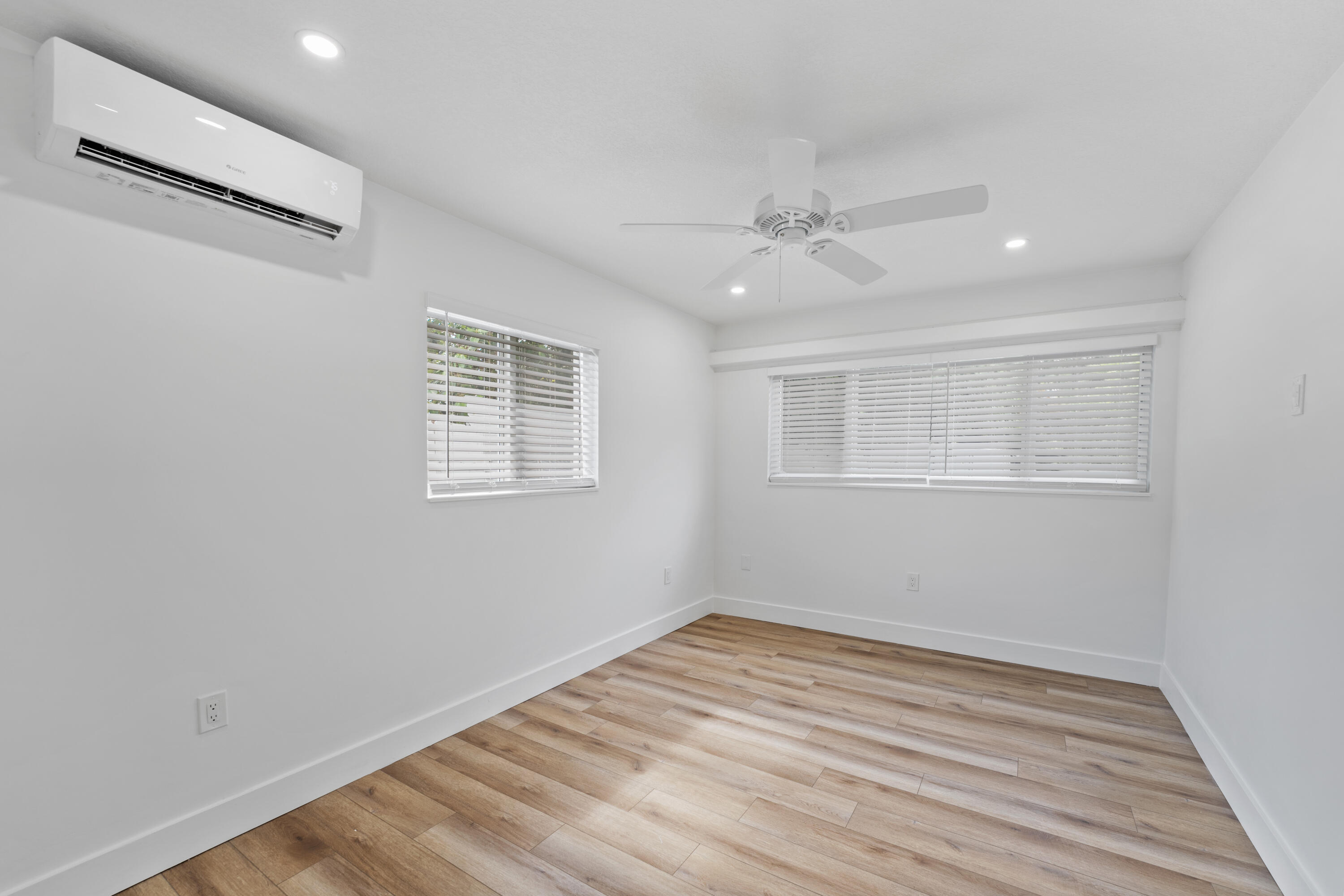 1279 Beach Road, Unit 2 Singer Island, FL 33404 - Photo 17 of 20 a view of empty room with wooden floor and fan