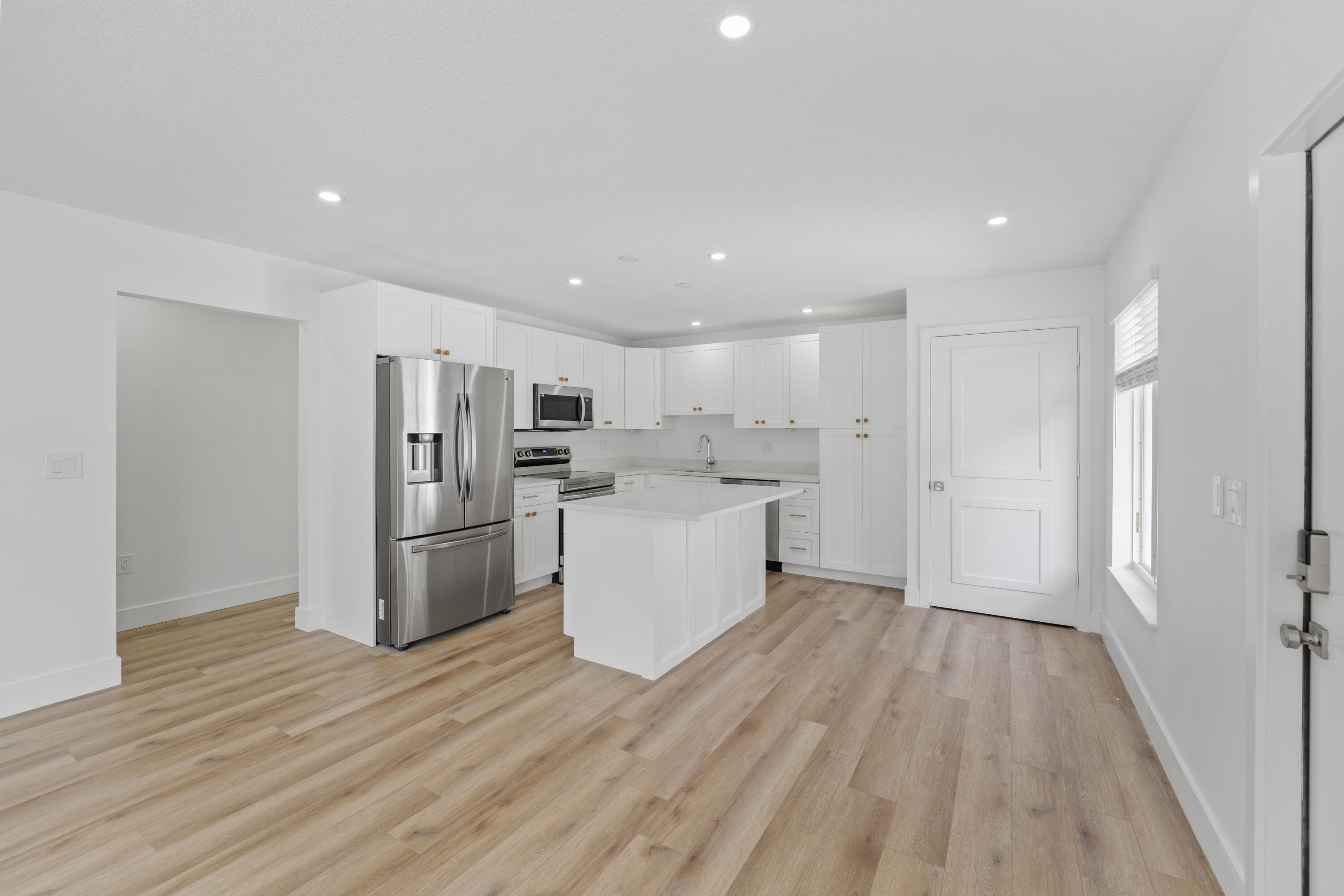 1279 Beach Road, Unit 2 Singer Island, FL 33404 - Photo 4 of 20 a kitchen with a refrigerator and a stove top oven