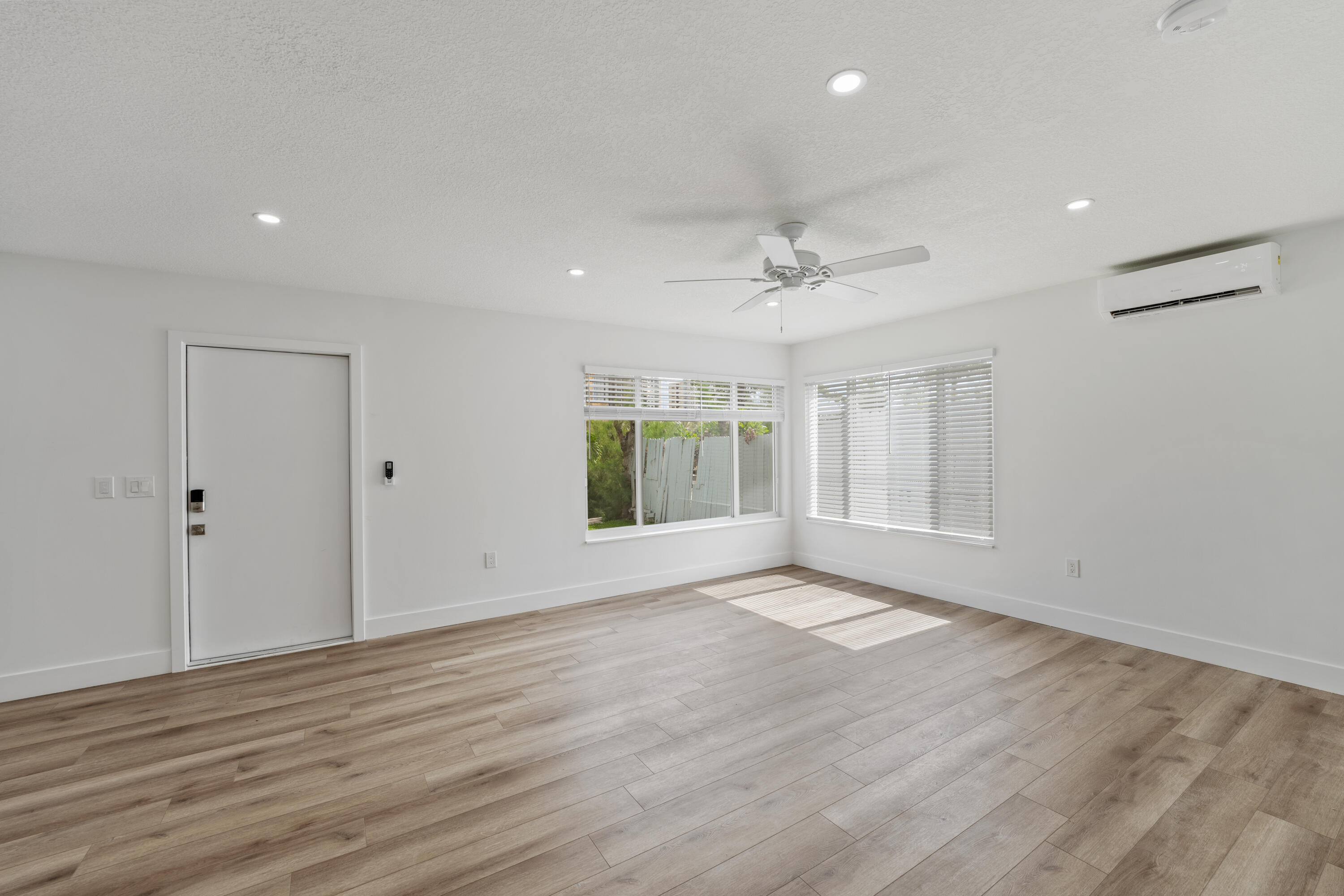 1279 Beach Road, Unit 2 Singer Island, FL 33404 - Photo 5 of 20 a view of an empty room with wooden floor and a window