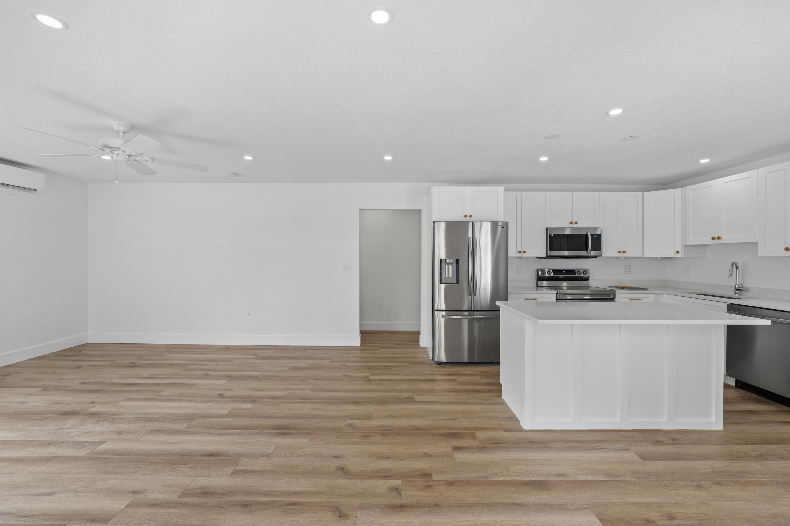 1279 Beach Road, Unit 2 Singer Island, FL 33404 - Photo 6 of 20 a view of kitchen with stainless steel appliances refrigerator stove microwave and cabinets