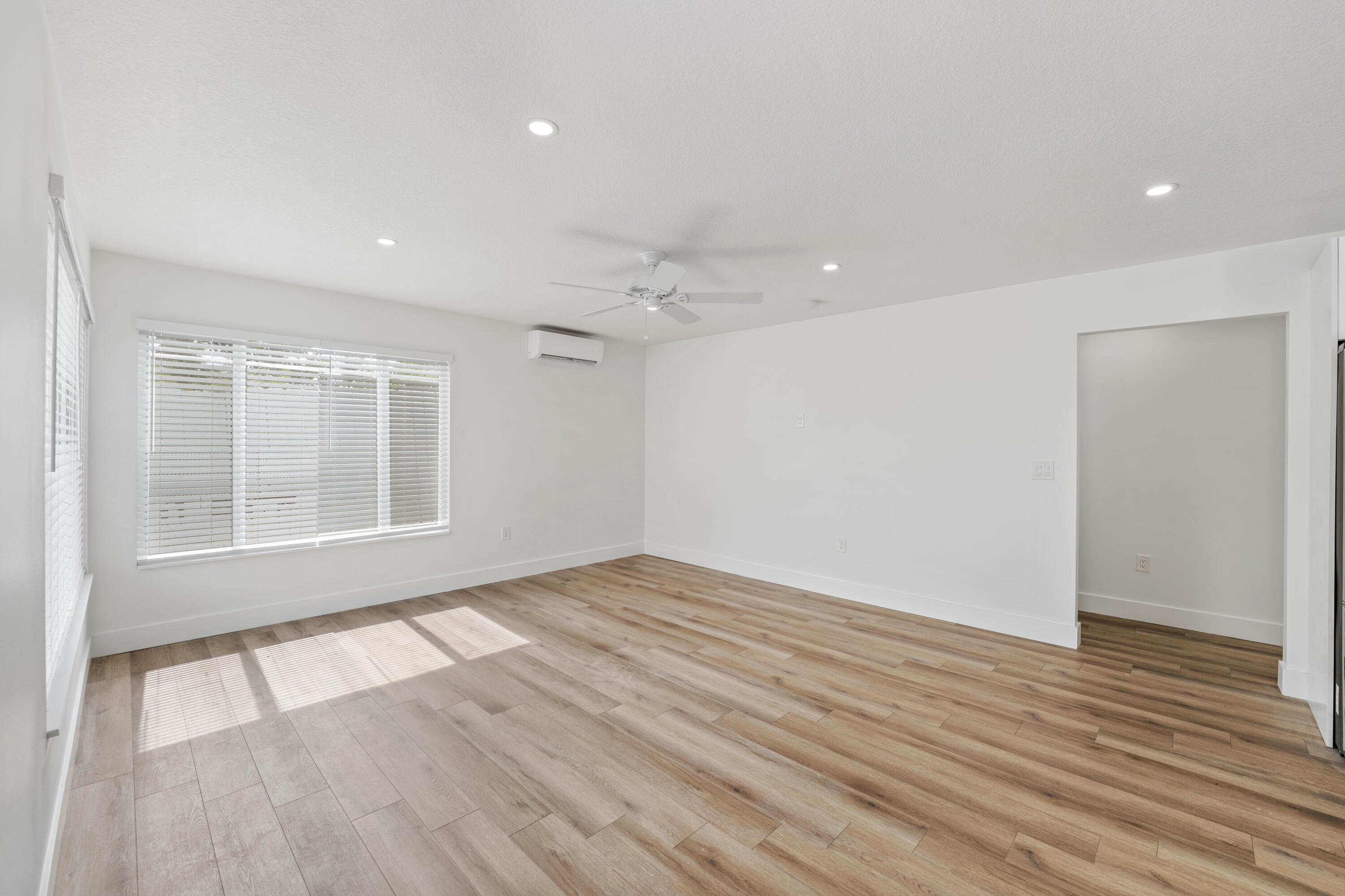 1279 Beach Road, Unit 2 Singer Island, FL 33404 - Photo 7 of 20 an empty room with wooden floor and windows