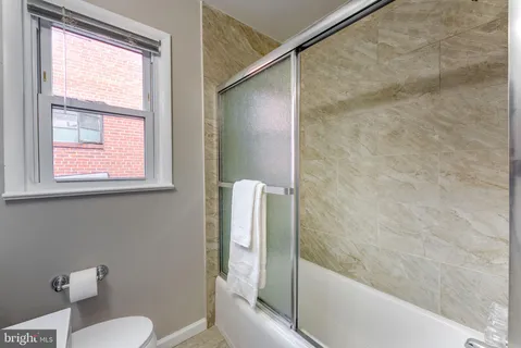 a bathroom with a shower and a toilet