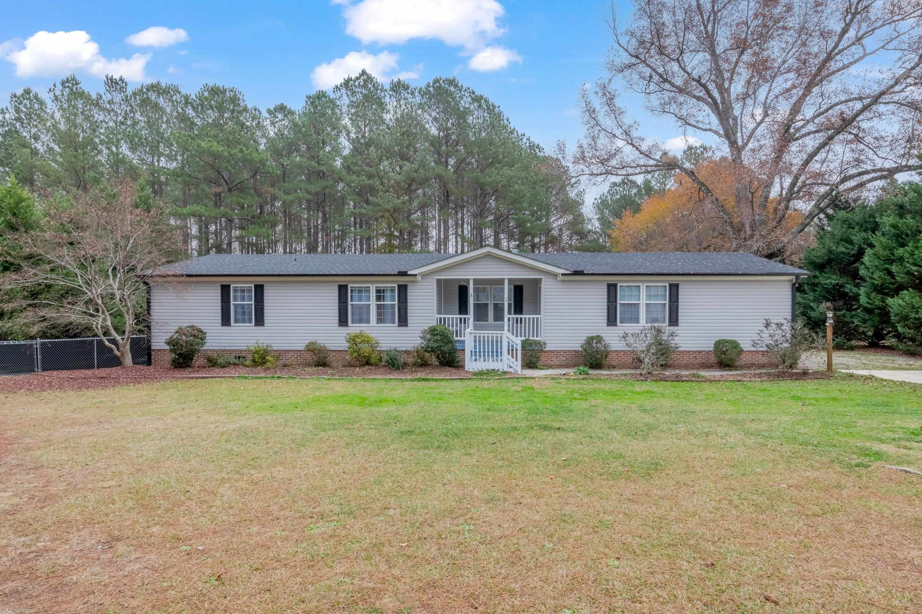 32 Red Oak Drive Smithfield, NC 27577 - Photo 1 of 47 a front view of a house with a garden and trees