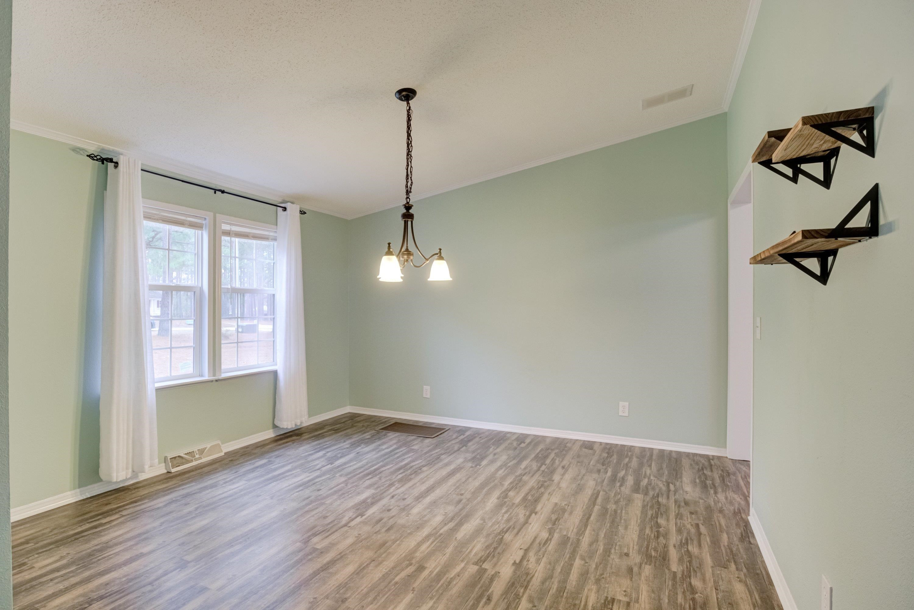 32 Red Oak Drive Smithfield, NC 27577 - Photo 11 of 47 a view of an empty room with a window and wooden floor