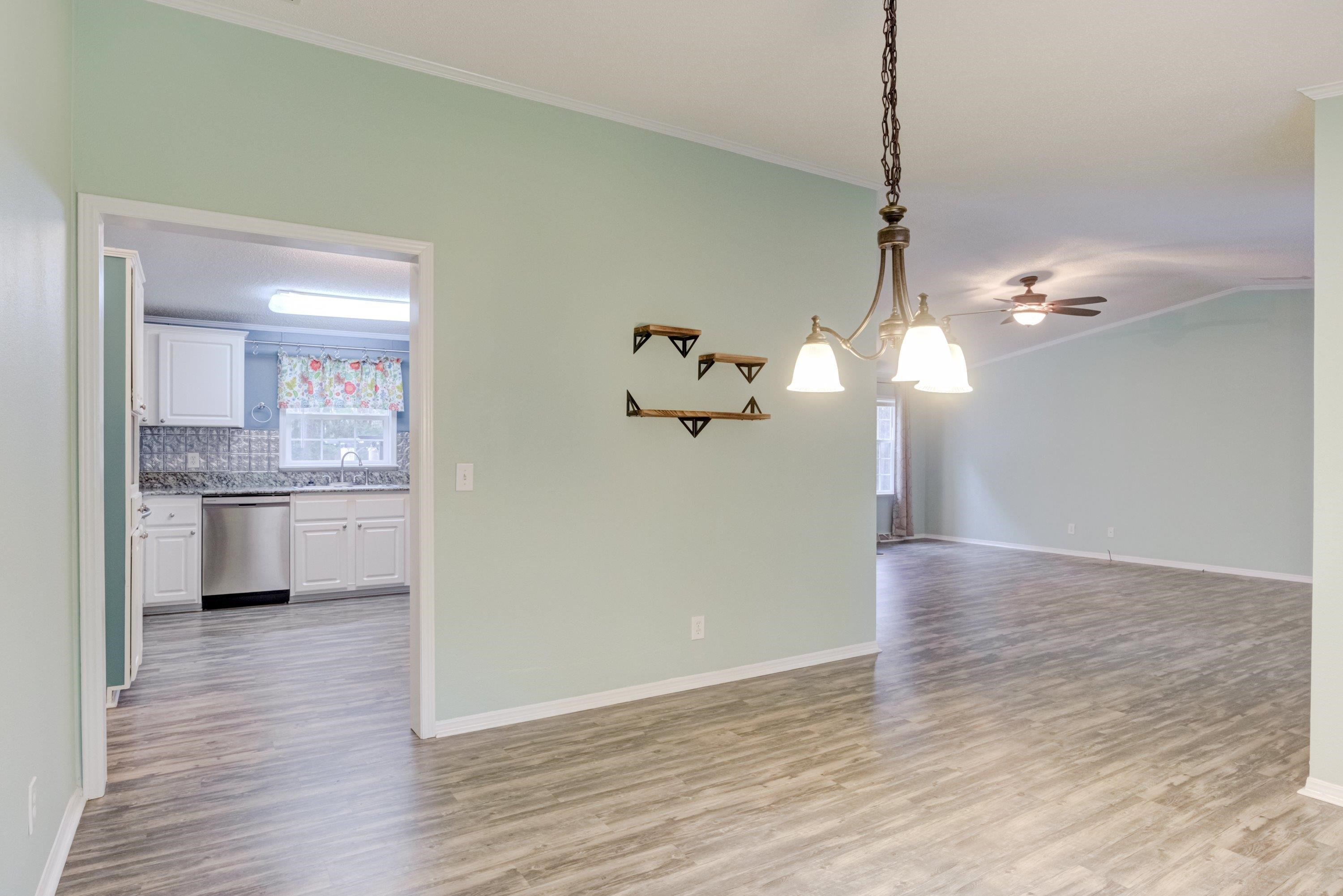 32 Red Oak Drive Smithfield, NC 27577 - Photo 12 of 47 a view of a kitchen with a sink dishwasher a kitchen island a stove and a wooden floors