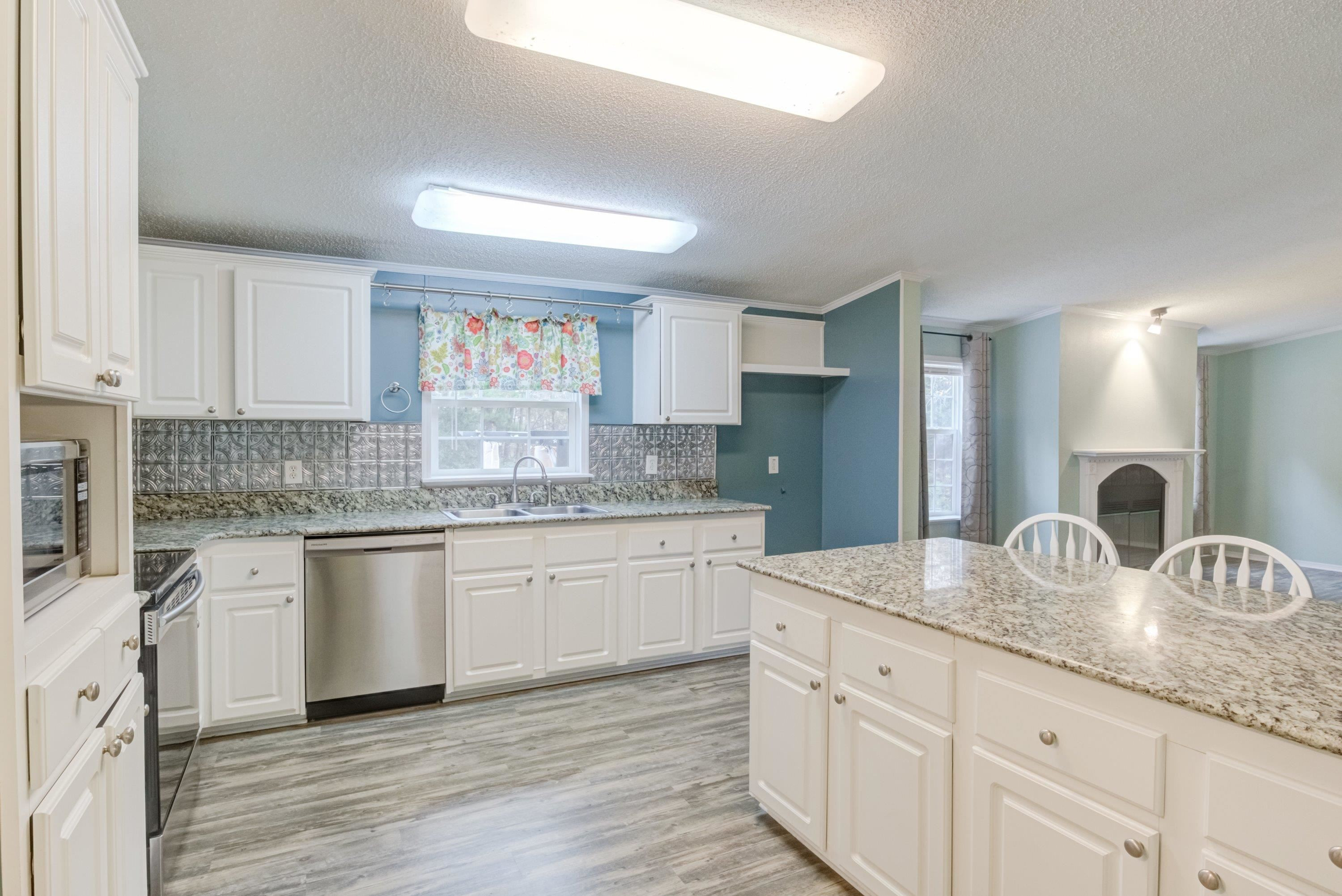 32 Red Oak Drive Smithfield, NC 27577 - Photo 16 of 47 a kitchen with granite countertop cabinets stainless steel appliances a sink and a counter top space