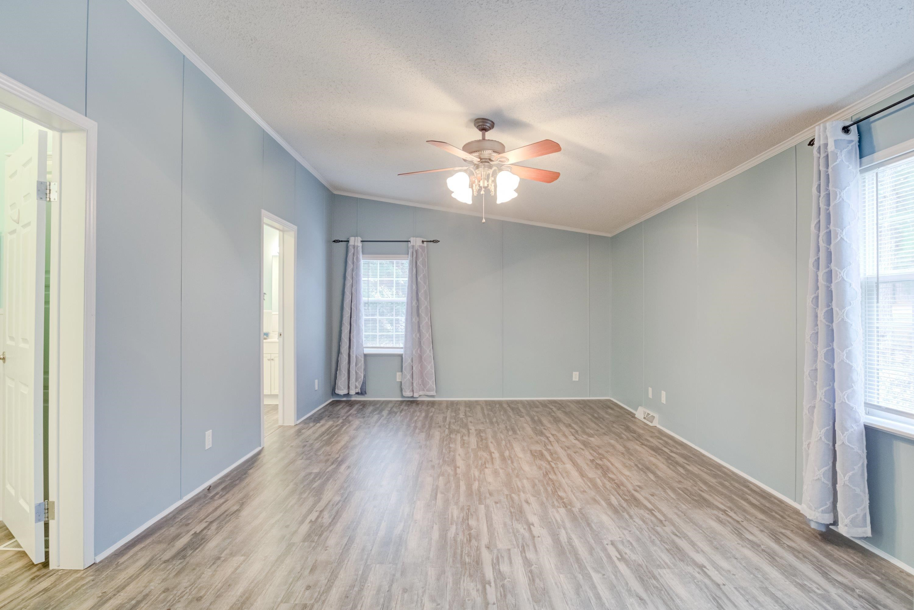 32 Red Oak Drive Smithfield, NC 27577 - Photo 19 of 47 a view of empty room with wooden floor and fan