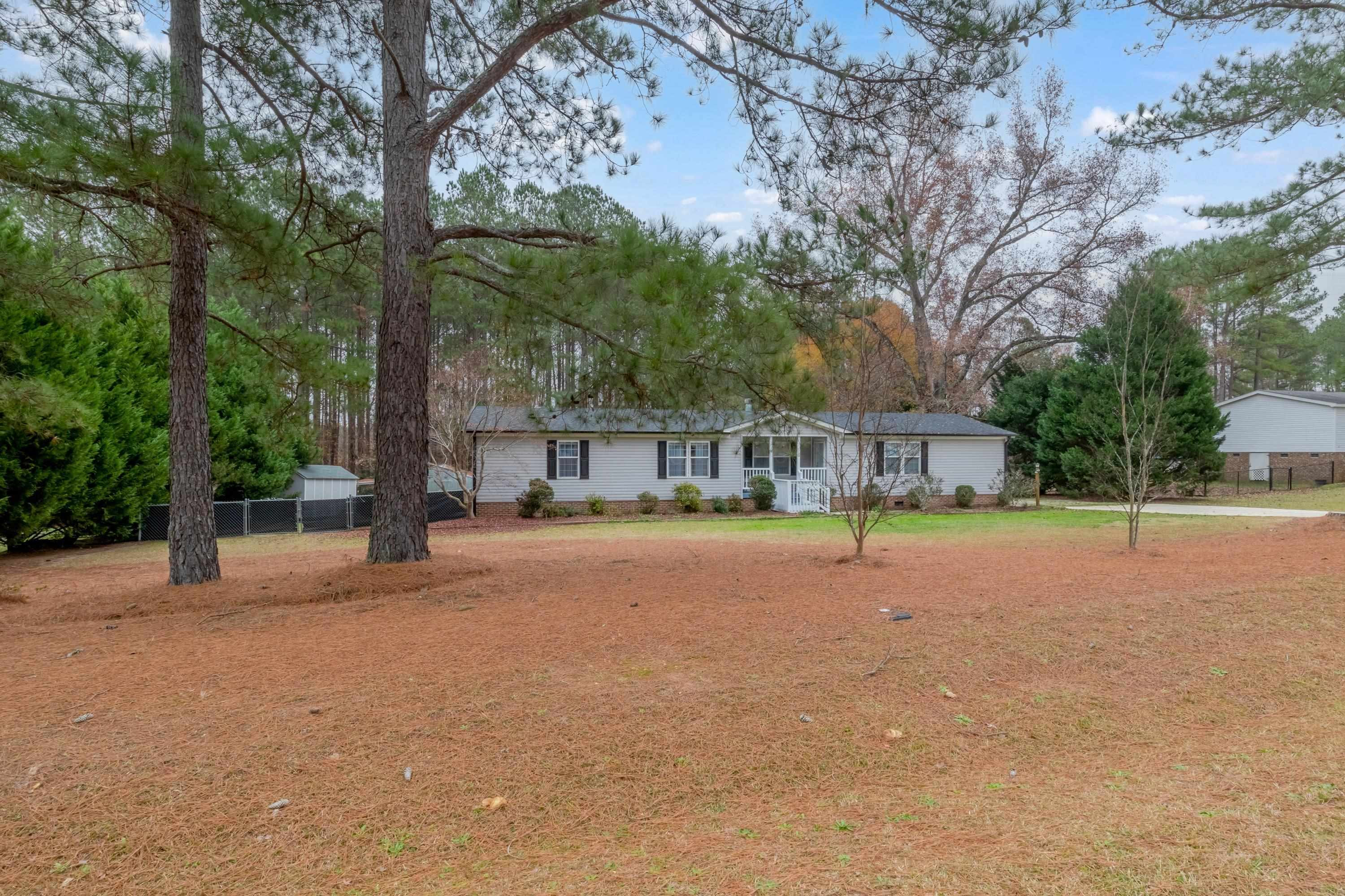 32 Red Oak Drive Smithfield, NC 27577 - Photo 2 of 47 a swimming pool with outdoor seating and yard