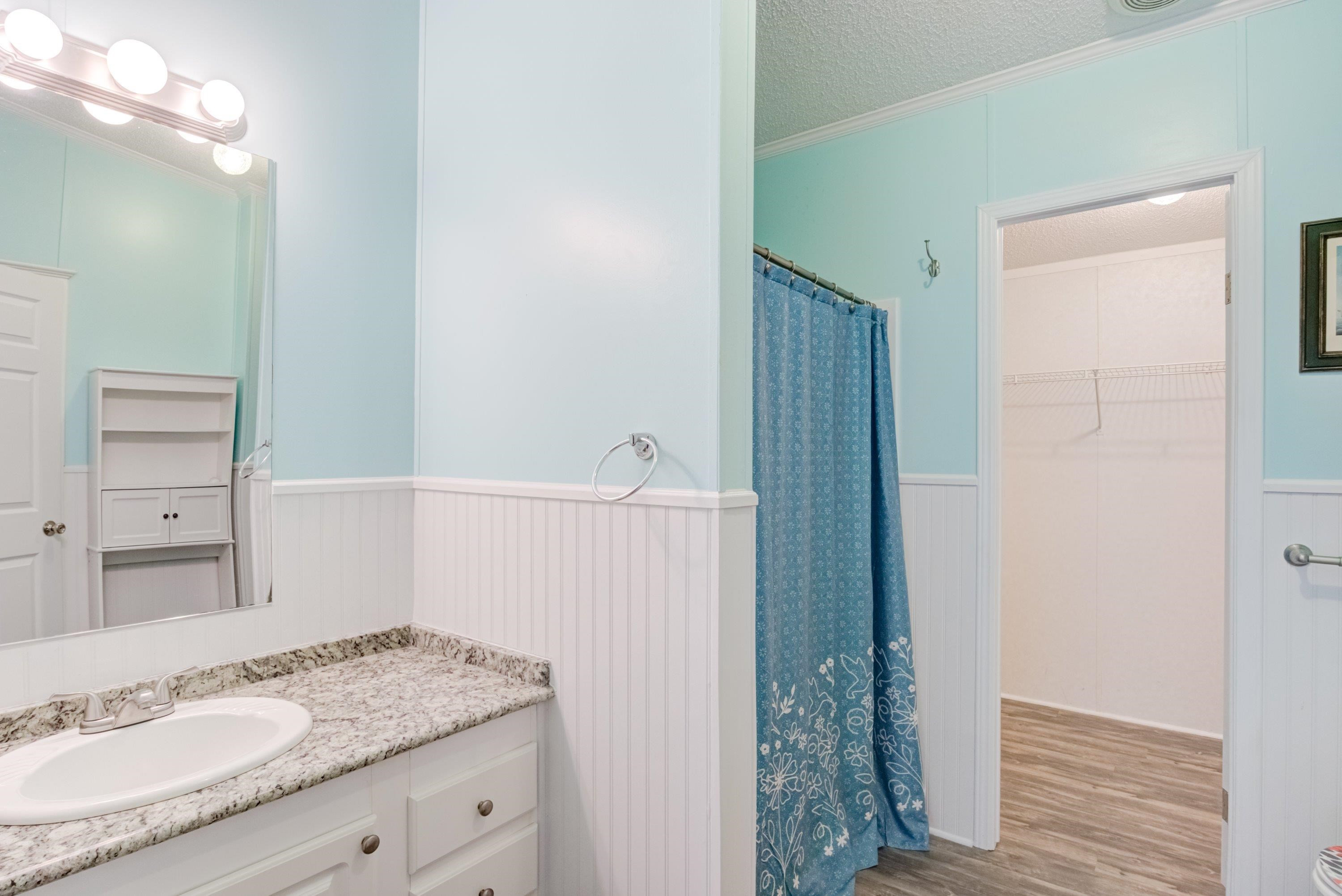 32 Red Oak Drive Smithfield, NC 27577 - Photo 27 of 47 a bathroom with a granite countertop sink a mirror and a shower