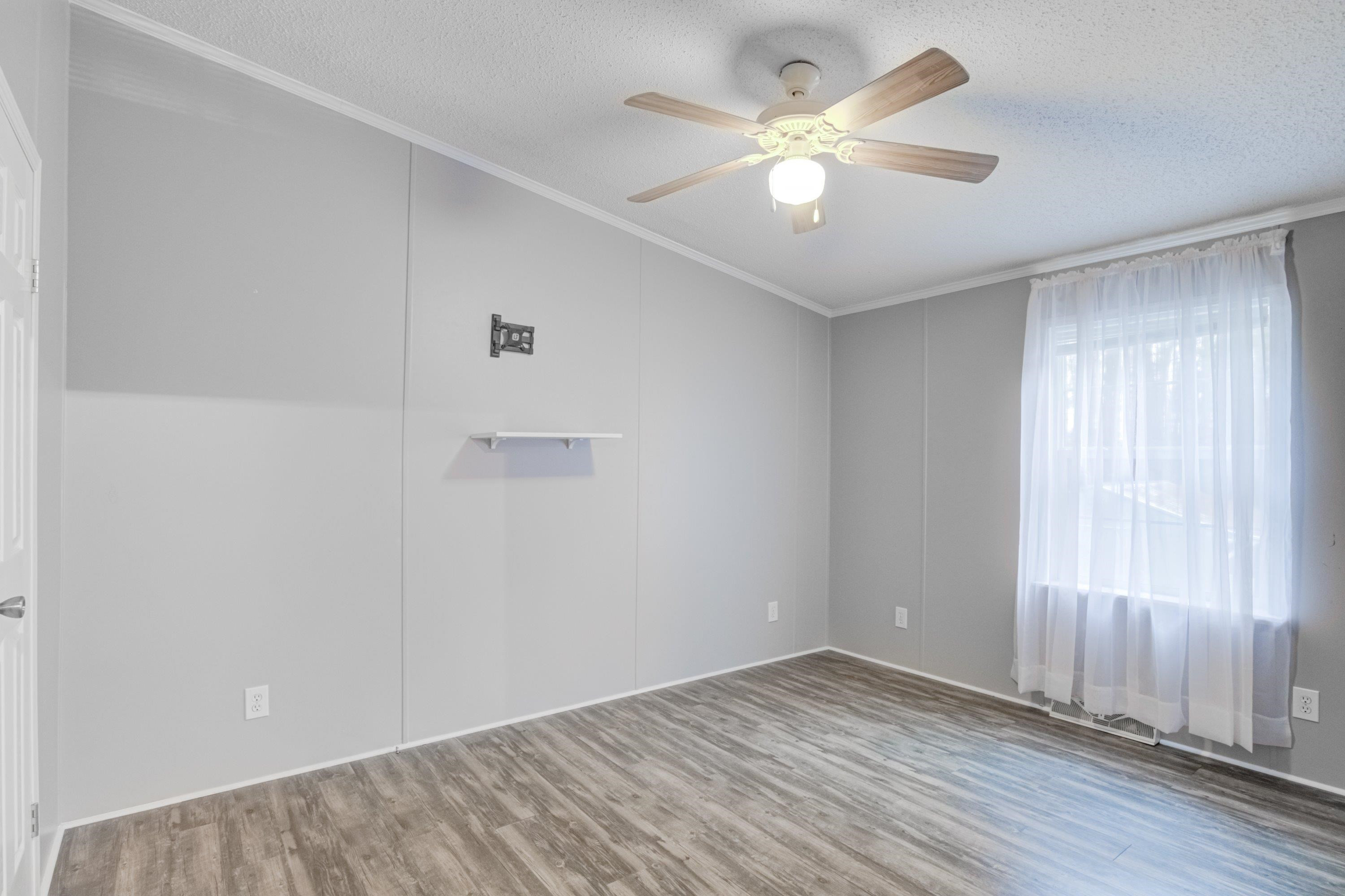 32 Red Oak Drive Smithfield, NC 27577 - Photo 31 of 47 an empty room with a window and a ceiling fan