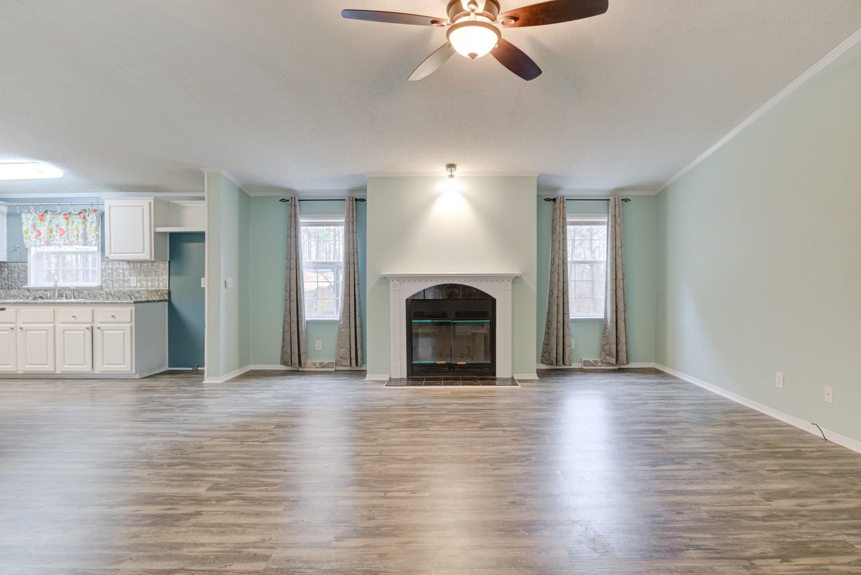 32 Red Oak Drive Smithfield, NC 27577 - Photo 7 of 47 a view of an empty room with window and wooden floor