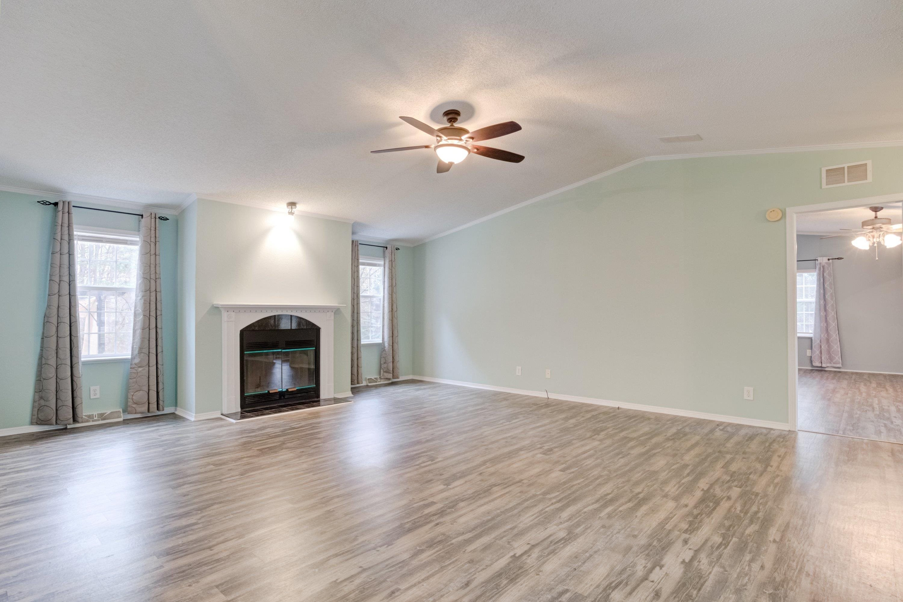 32 Red Oak Drive Smithfield, NC 27577 - Photo 8 of 47 a view of empty room with wooden floor and fan