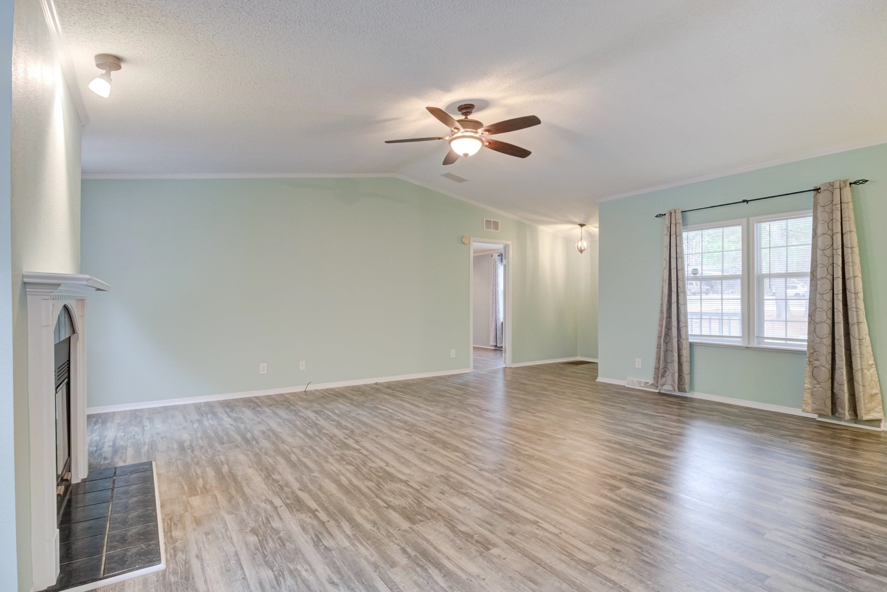 32 Red Oak Drive Smithfield, NC 27577 - Photo 9 of 47 a view of an empty room with window and wooden floor