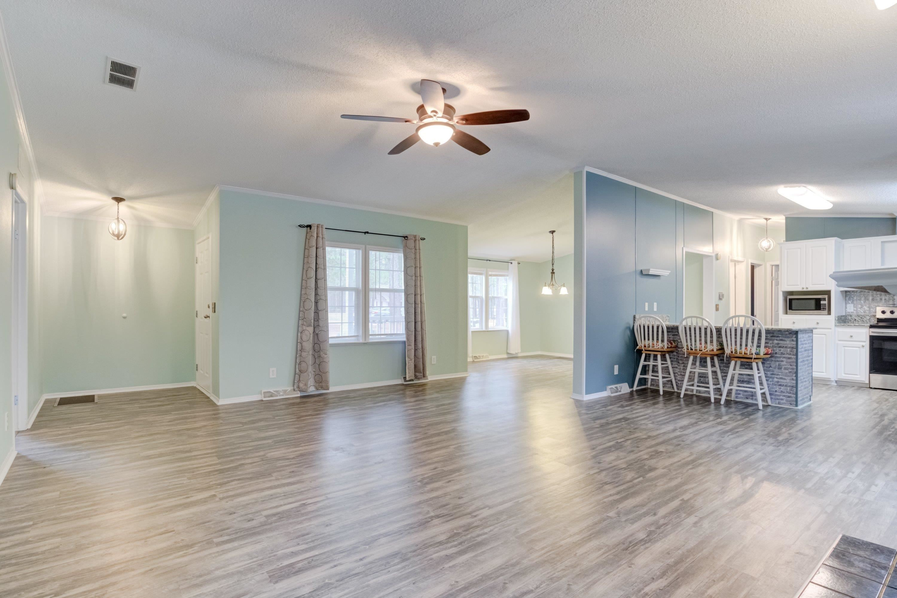 32 Red Oak Drive Smithfield, NC 27577 - Photo 10 of 47 a view of a livingroom with furniture wooden floor and a ceiling fan