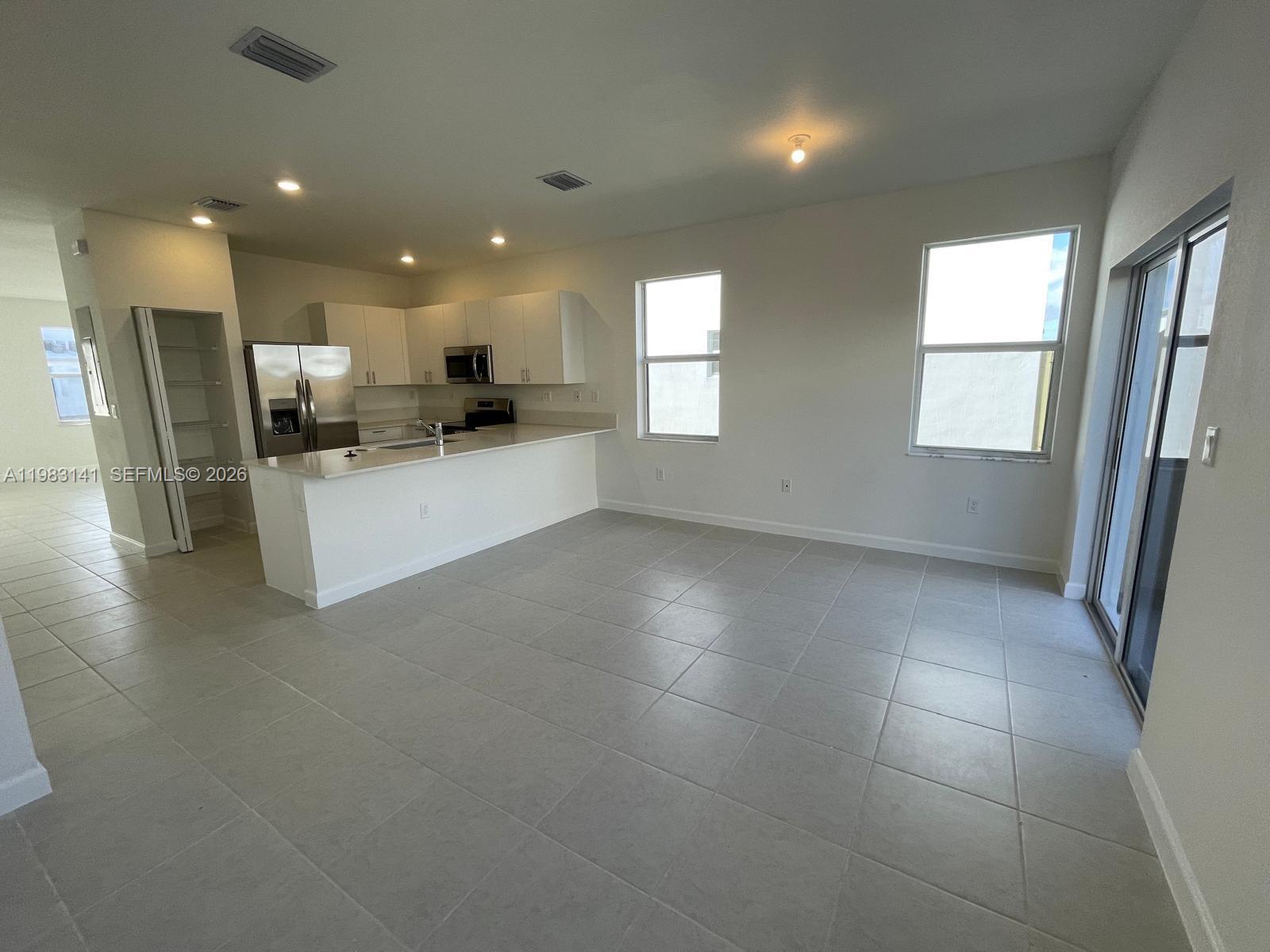 16283 Southwest 292nd Street Homestead, FL 33033 - Photo 4 of 12 a view of kitchen with refrigerator and window
