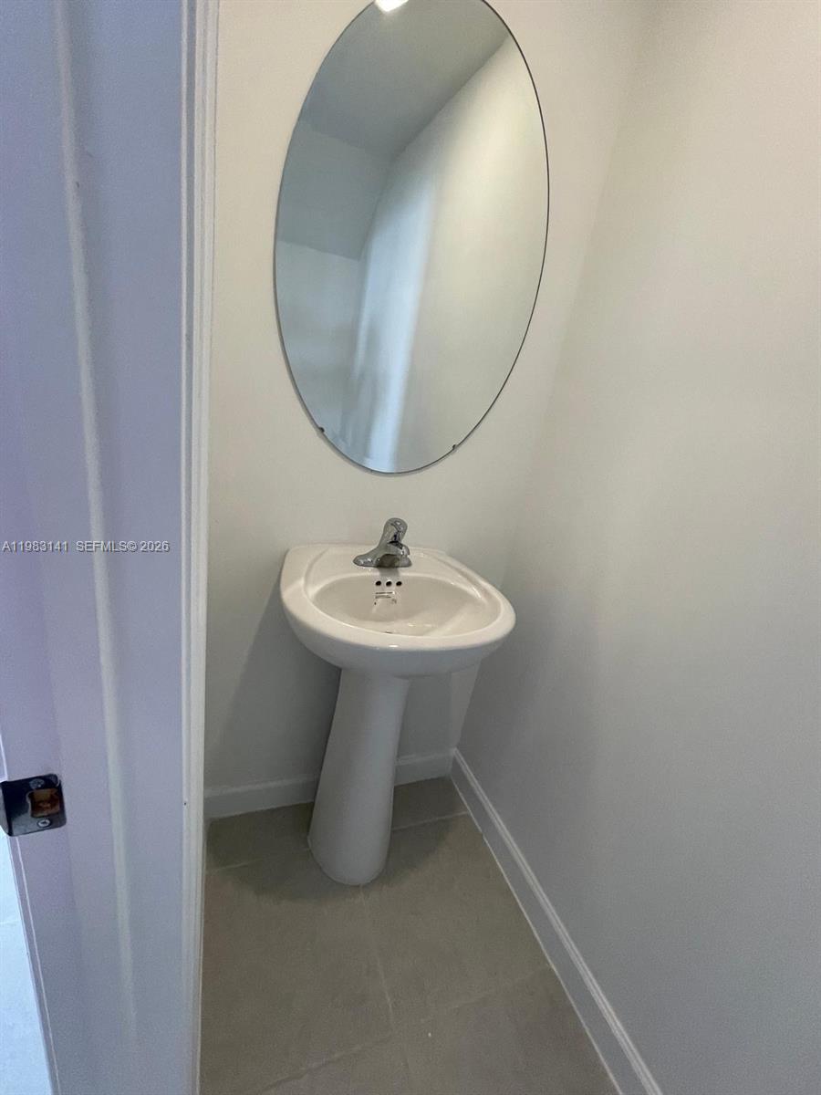 16283 Southwest 292nd Street Homestead, FL 33033 - Photo 5 of 12 a bathroom with a sink a mirror and a toilet