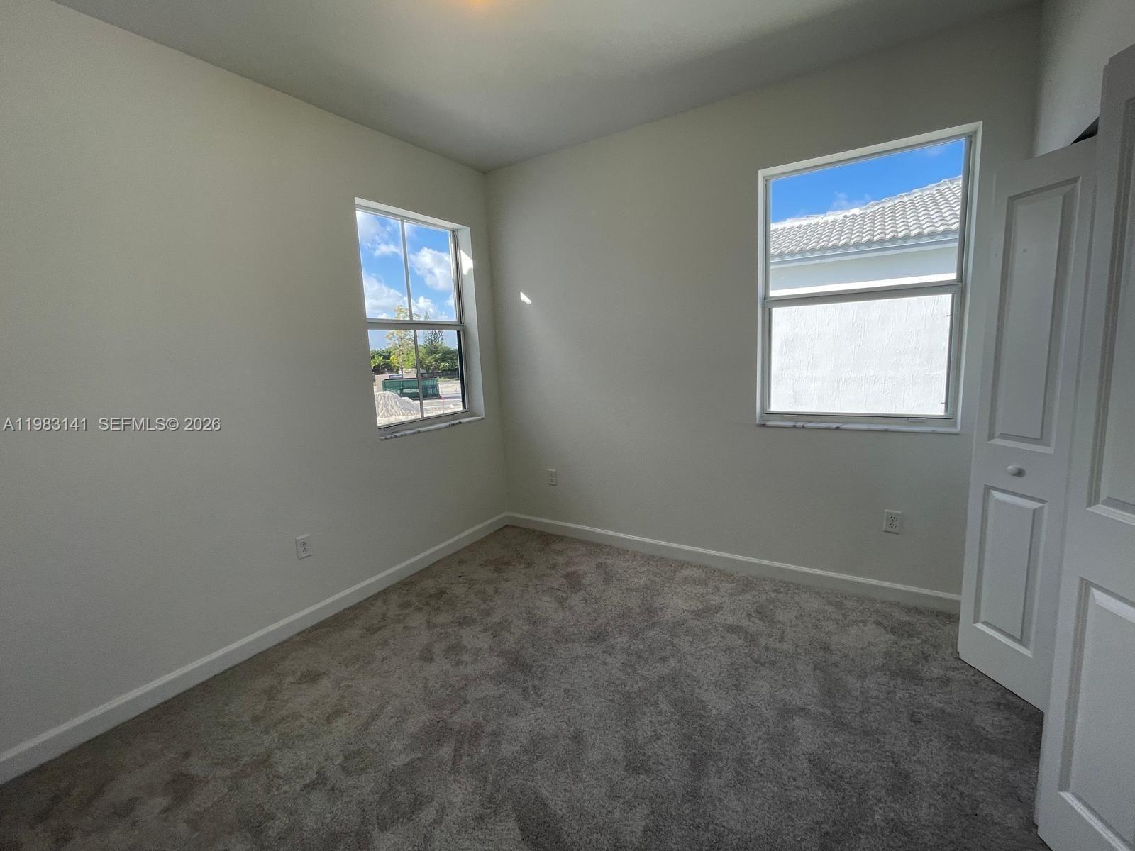 16283 Southwest 292nd Street Homestead, FL 33033 - Photo 6 of 12 an empty room with windows