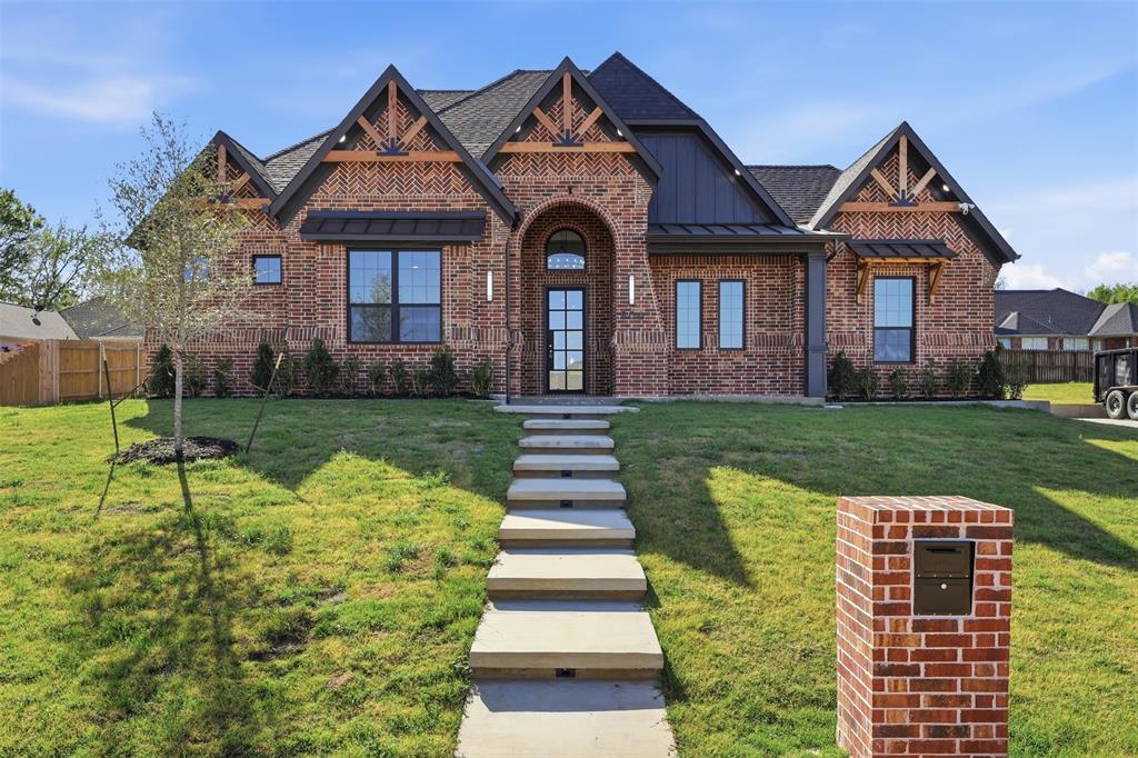 a front view of a house with a yard