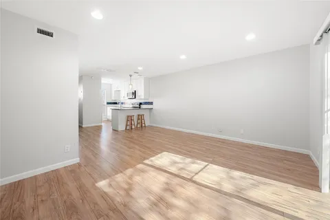 a view of a kitchen with a sink and wooden floor